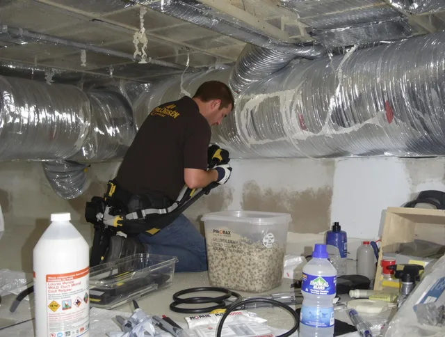 West Warwick Air Duct Cleaning specialist performing professional mold removal from air ducts in West Warwick