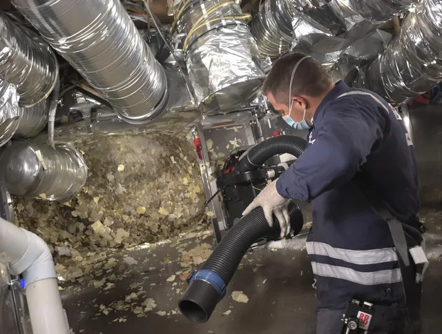 West Warwick Air Duct Cleaning specialist operating negative pressure cleaning equipment for thorough duct maintenance in West Warwick