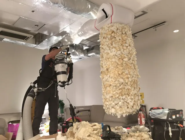 West Warwick Air Duct Cleaning technician performing precision vacuum insulation removal in a residential property in West Warwick